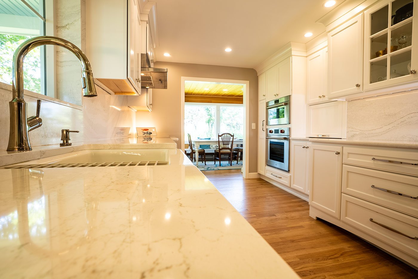 Bright kitchen with marble counters and modern fixtures by Oxland Builders in New Hampshire Bright kitchen with marble counters and modern fixtures by Oxland Builders in New Hampshire